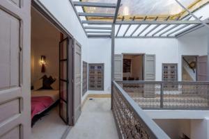 a room with a balcony with a bedroom and a bed at Riad Slima en exclusivité petits déjeuners compris in Marrakesh