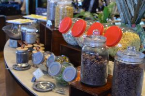 a table topped with jars of food and other items at Le Meridien Kota Kinabalu in Kota Kinabalu