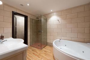 a bathroom with a tub and a sink and a shower at Las Fajanas de Gáldar in Las Palmas de Gran Canaria
