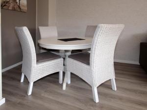 een witte eettafel met 2 stoelen en een tafel bij Apartment in Berumbur in Berumbur