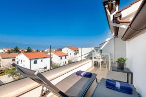 a balcony with a chair and a table and a view at Apartment Lili in Poreč