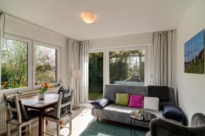 a living room with a couch and a table at Ferien Bei Familie Martin in Bad Zwischenahn