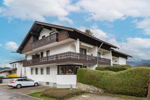 a house with a car parked in front of it at Ferienwohnung Panoramablick - Alpenmagie Suites in Oberaudorf