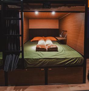 a bunk bed with two pillows on top of it at Autumn Living Hotel in Surabaya