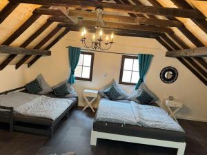 a bedroom with two beds and a chandelier at 4711 Suite in Siegburg