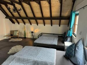 a bedroom with two beds and a wooden ceiling at 4711 Suite in Siegburg