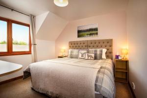 a bedroom with a large bed and a window at Beechwood Lodge Guesthouse in Alness