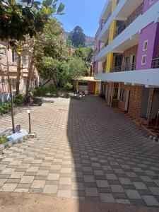 a cobblestone street in a town with buildings at Royal Queen Residency in Ooty