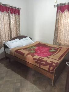 a large bed in a room with curtains at Royal Queen Residency in Ooty