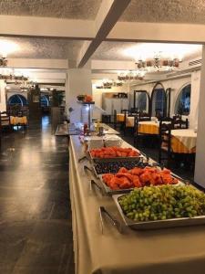 a buffet line with different types of fruits and vegetables at Karteros Hotel in Karteros +37 photos
