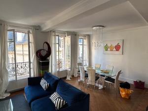 sala de estar con sofá azul y mesa en Trouville centre en Trouville-sur-Mer