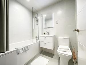 a white bathroom with a toilet and a shower at LIVINGWAY Roco in Liverpool