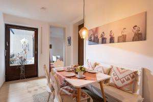 a dining room with a table and chairs at Ferienwohnung Kranzhornblick - Alpenmagie Suites in Oberaudorf