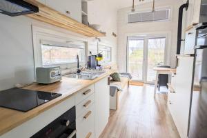 a kitchen with a sink and a counter top at Tiny House Mila in Brandenburg an der Havel