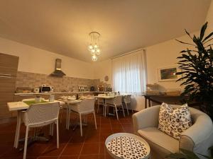 a kitchen and living room with a couch and a table at La Nuova Dimora B&B in LʼAquila