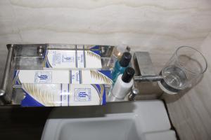 - un comptoir avec un lavabo, des brosses à dents et un verre dans l'établissement Javson Airport Hotel, à Sialkot