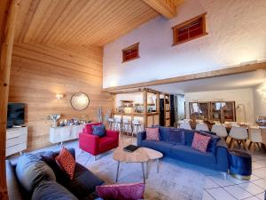 a living room with a blue couch and red chairs at Chez Claudius- appartement-10 pers-proche piste in Les Gets