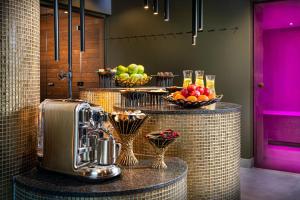 a dessert bar with fruit in baskets on a counter at FAVORITE Parkhotel I Spa - Business - Fine Dining in Mainz