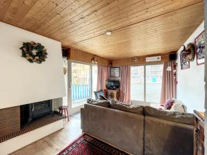 a living room with a couch and a fireplace at Pied de ladroit - appartement - 4 pers - centre in Les Gets