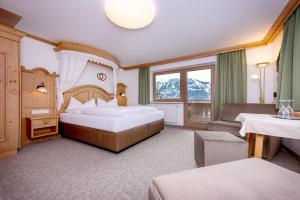 a hotel room with two beds and a window at Astegg, Alpengasthof in Finkenberg