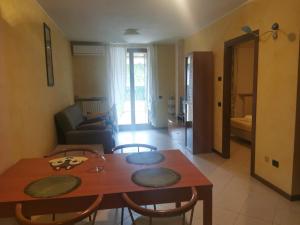 a dining room table and chairs in a living room at Caba Holiday Bardolino Pasubio in Bardolino