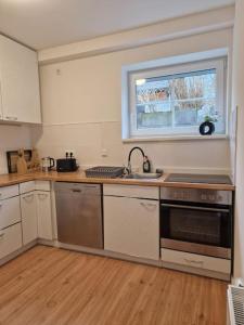 a kitchen with stainless steel appliances and a window at -NEUE- Ferienwohnung - Monteurwohnung in Lippe in Lage