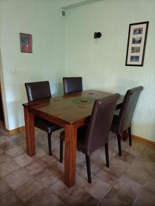 a wooden table with four chairs around it at Forest 104 in Vielsalm