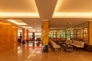 a lobby with chairs and tables in a building at Tara Lake in Bangkok
