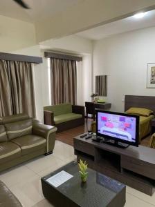 a living room with a couch and a television at Bayou Bliss@Bayou Lagoon in Ayer Keroh
