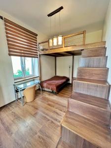 a room with stairs and a bed and a desk at Cozy rooms in Old Town and Wawel in Krakow