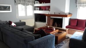 a living room with two couches and a fireplace at Beautiful house in Epanomi