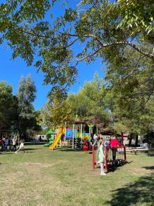 a group of people standing around a playground at Agroturizem Eldi in Fier