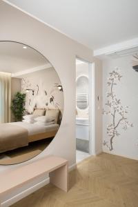 a bedroom with a round mirror and a bed at Eagle's Nest Ljubljana in Ljubljana