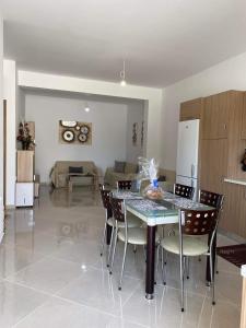 a dining room and living room with a table and chairs at Rhodes Volkshaus in Afantou +8 photos