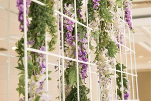 a bunch of flowers hanging from a white rack at htop Amatista #htopBliss in Lloret de Mar