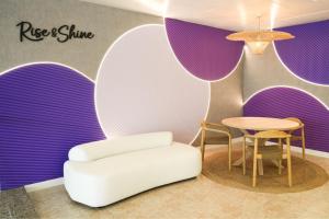 a room with a white chair and a table at htop Amatista #htopBliss in Lloret de Mar