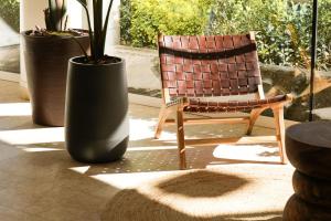 a chair and a large vase sitting on a patio at htop Amatista #htopBliss in Lloret de Mar