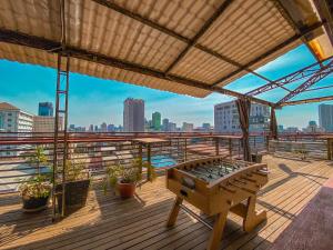 a wooden deck with a view of a city skyline at Le Casablanca Hotel in Phnom Penh