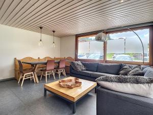 a living room with a couch and a table at Mont Caly - appartement - 8 pers - centre in Les Gets