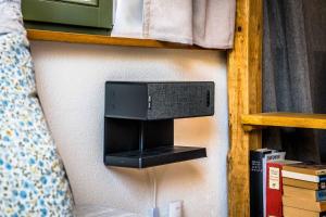 a speaker on a wall next to a bed at Besighomes Apartment Loft in Besigheim