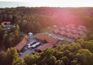 an aerial view of a house with a parking lot at Hotel Palanga Camping Compensa in Palanga