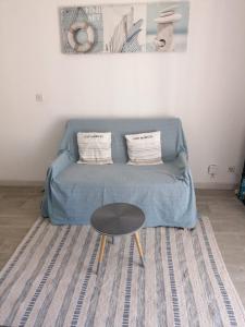 - un canapé avec deux oreillers et une table dans l'établissement Appartement Romantic Sea, au Barcarès