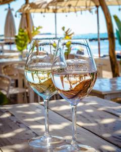 two glasses of wine sitting on top of a table at MOBILE HOME CLIMATISE Vias 2 in Vias