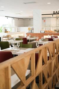a dining room with tables and chairs and a restaurant at htop Amatista #htopBliss in Lloret de Mar