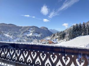 a view of a snow covered mountain from a bridge at Cornuts 2 - appartement -5pers in Les Gets