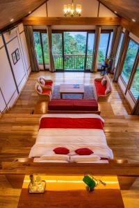 a large bed in the middle of a room with windows at Eagle's Nest in Bhurtuk