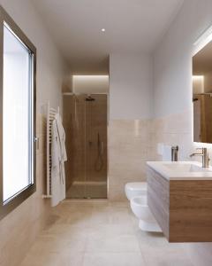 a bathroom with a shower and a toilet and a sink at Marysel Rooms in Olbia