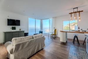 a living room with a couch and a table at Karat Villa Sound of the Sea in Tacoronte