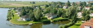 an aerial view of a house on an island in the water at Starvilla in Makkum mit Sauna und schöner Aussicht in Makkum