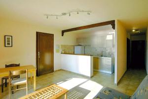 a kitchen and dining room with a table and a counter at Residence Les Dauphins in Tiuccia with balcony in Casaglione